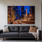Michigan Avenue Canvas Wall Art | Holiday Lights by the Water Tower canvas hanging above a charcoal sofa in a living room