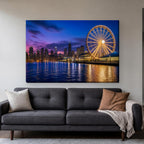 Navy Pier Canvas Wall Art | Ferris Wheel at Blue Hour canvas hanging above a charcoal sofa in a living room