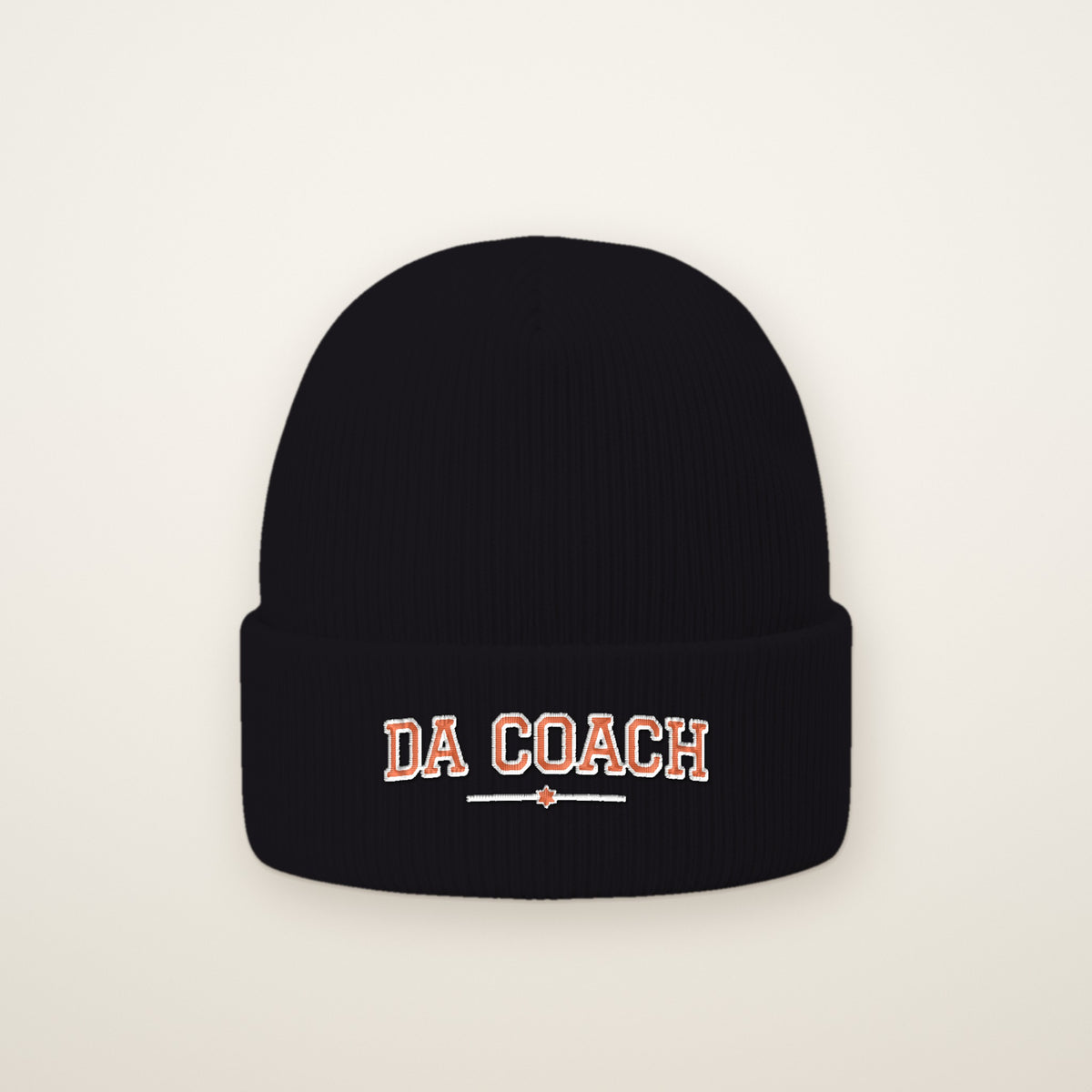 Da Coach Embroidered Cuffed Beanie in Black, flat lay on ivory
