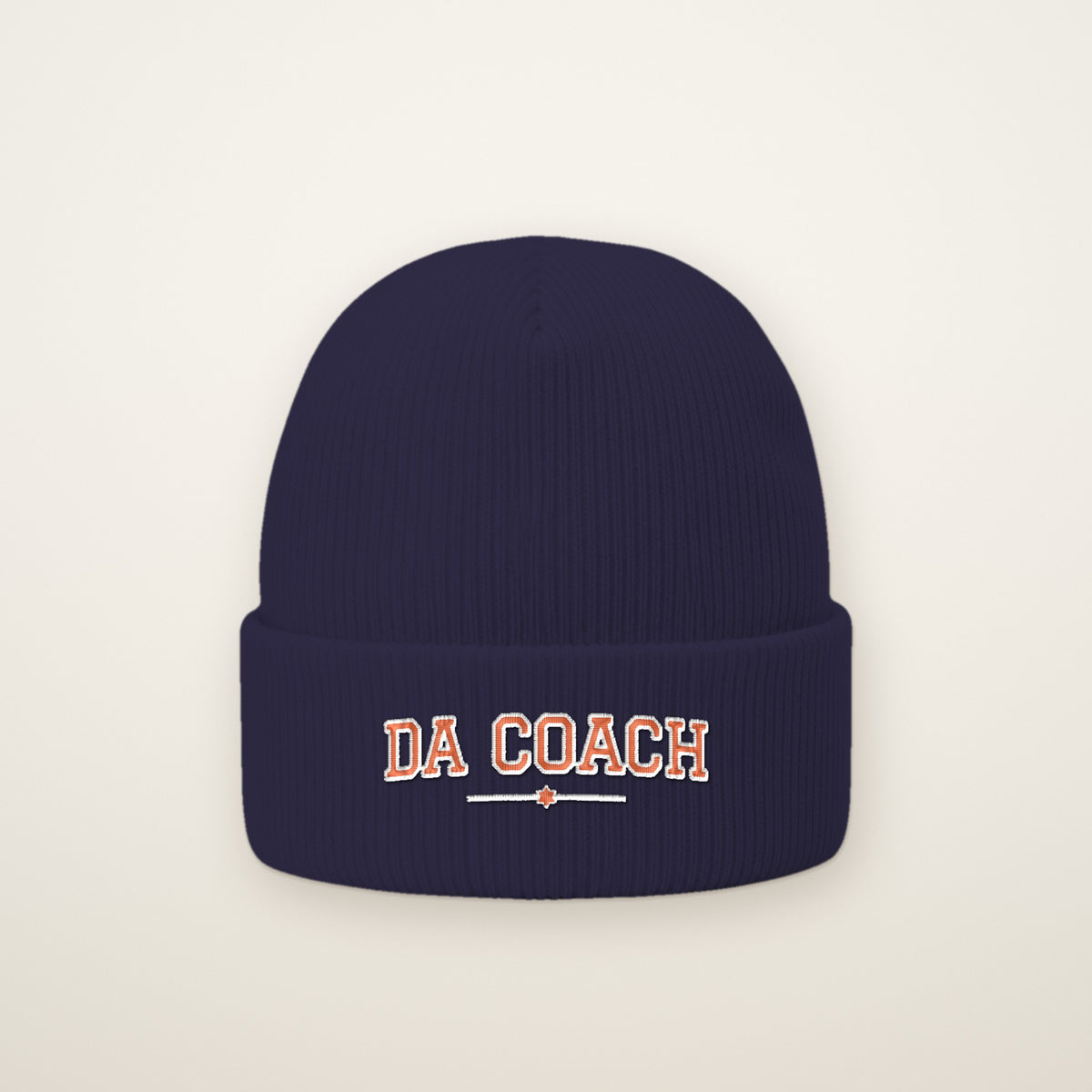 Da Coach Embroidered Cuffed Beanie in Navy, flat lay on ivory