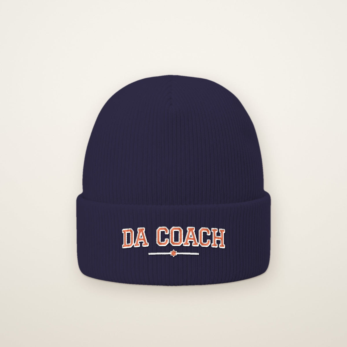 Da Coach Embroidered Cuffed Beanie in Navy, flat lay on ivory