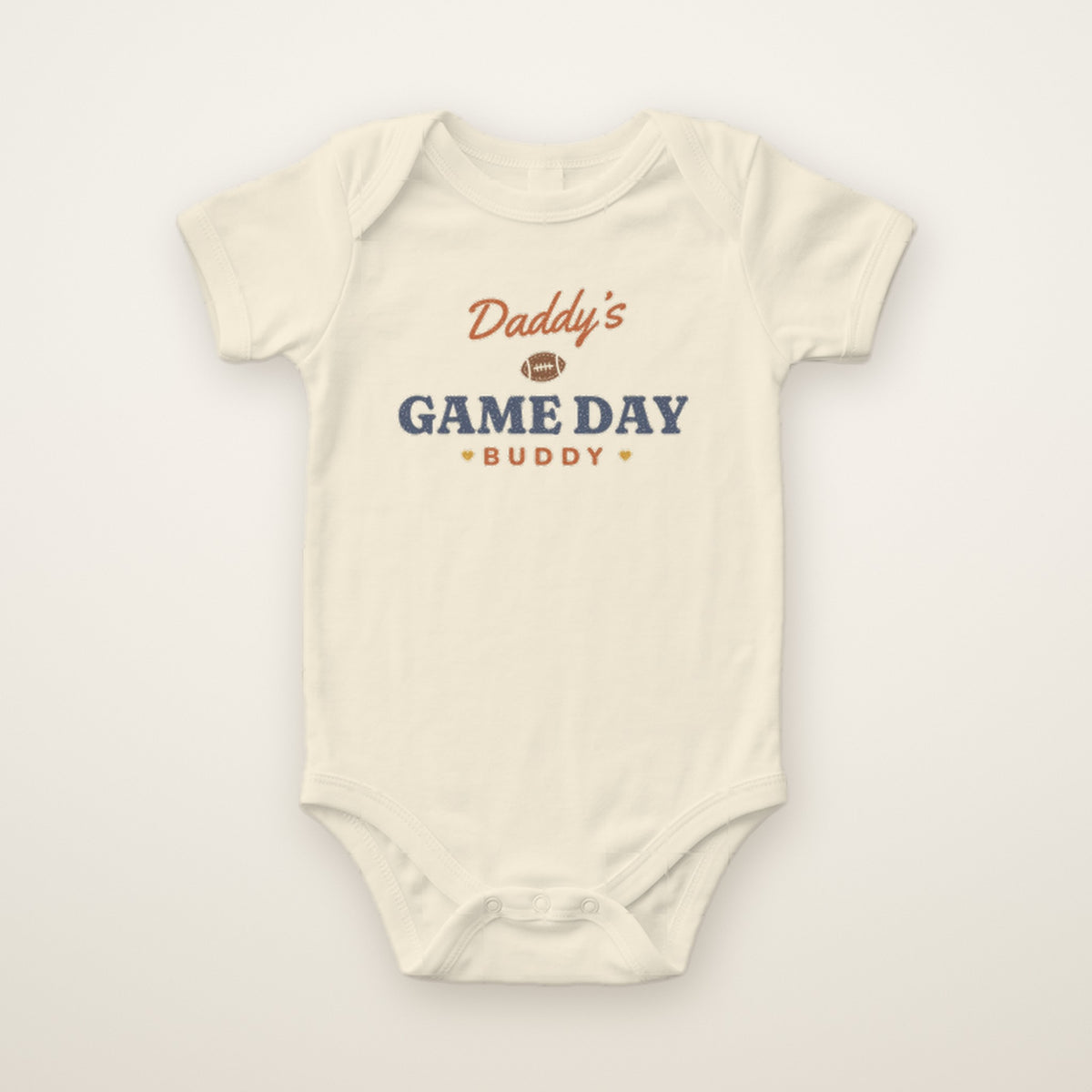 Daddy's Game Day Buddy Bodysuit in Natural, flat lay on ivory