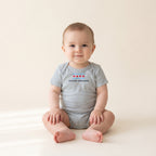 Baby wearing the Little Chicago Four Star Baby Bodysuit in Heather
