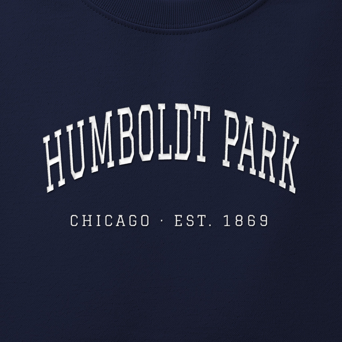 Close-up of white satin-stitch Humboldt Park embroidery
