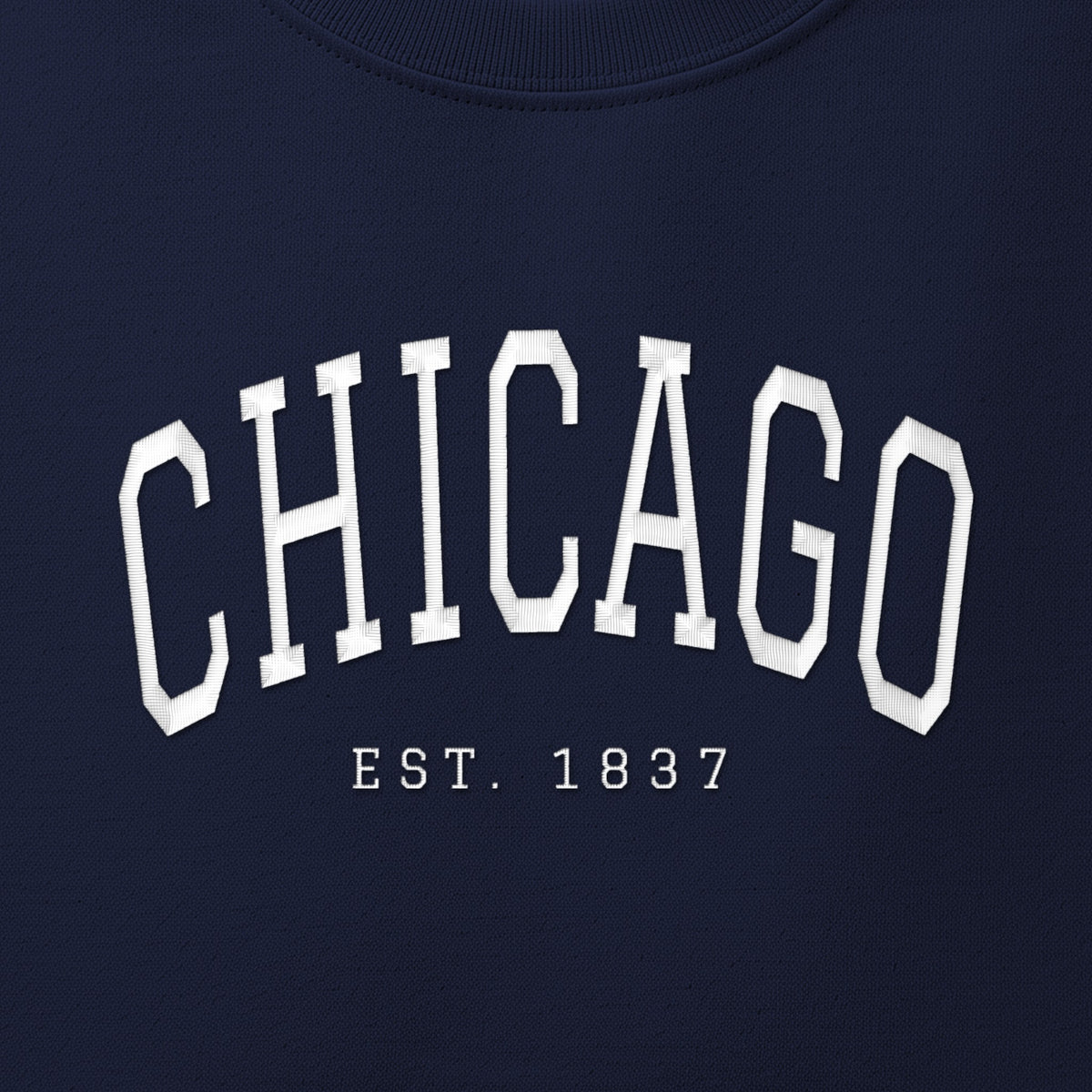 Close-up of white satin-stitch Chicago embroidery