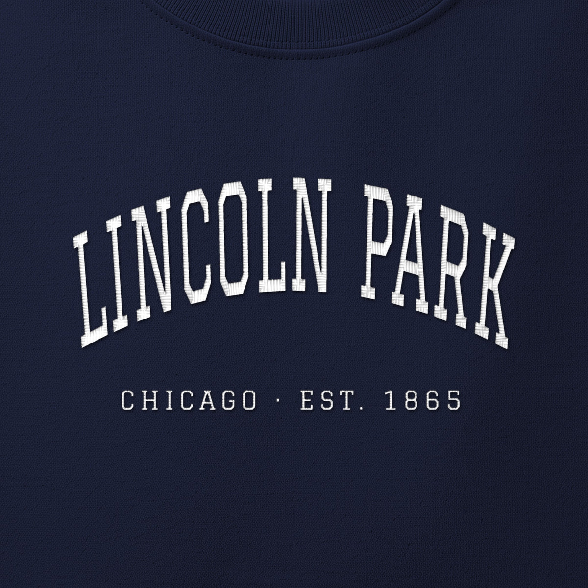 Close-up of white satin-stitch Lincoln Park embroidery