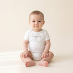 Baby wearing the Little Chicagoan Baby Bodysuit in White