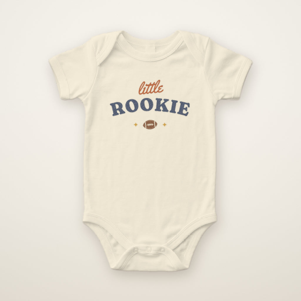 Little Rookie Bodysuit in Natural, flat lay on ivory
