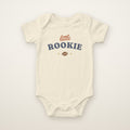 Little Rookie Bodysuit in Natural, flat lay on ivory