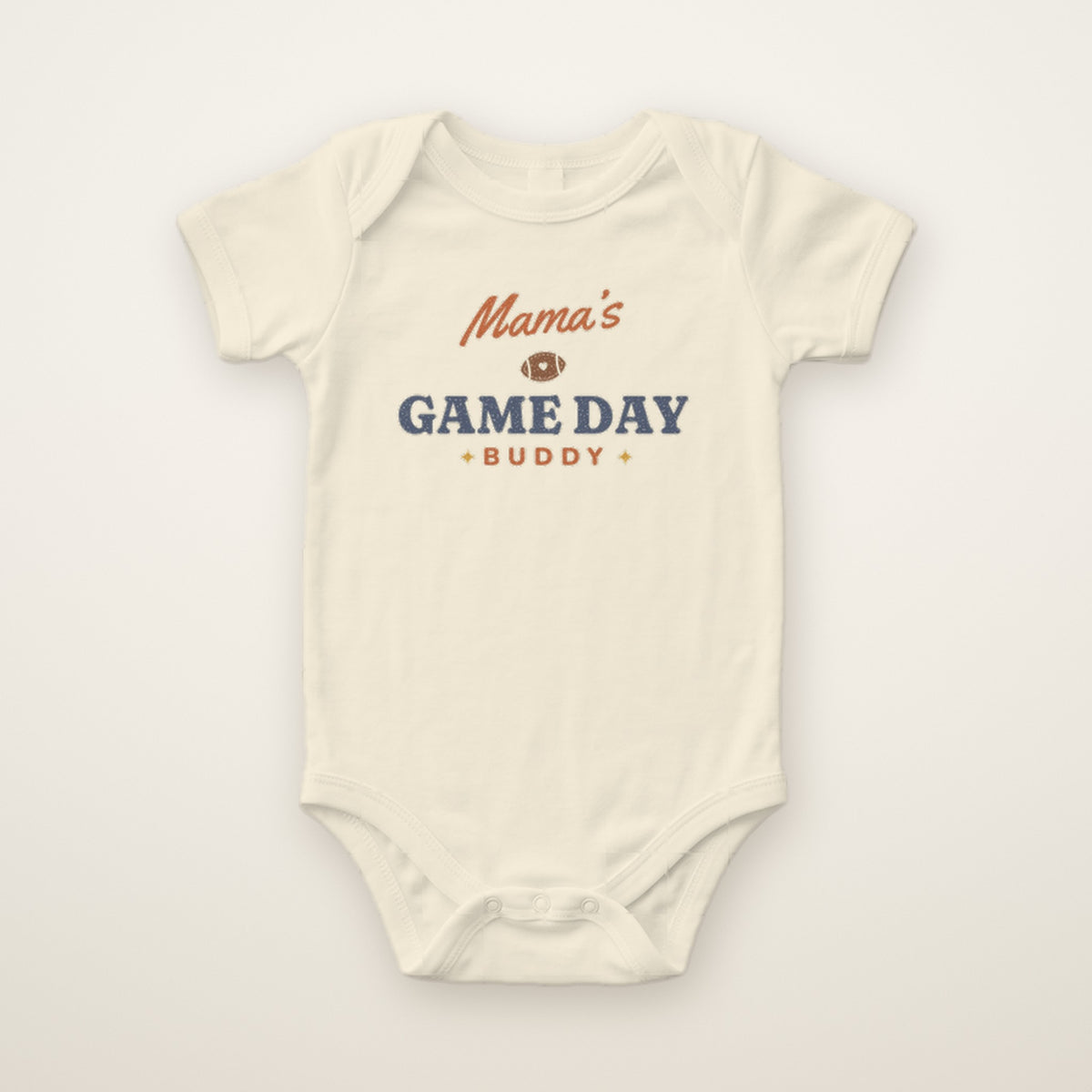 Mama's Game Day Buddy Bodysuit in Natural, flat lay on ivory