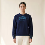 Model wearing the Old Town Chicago Embroidered Crewneck — Sky Blue Thread in Navy