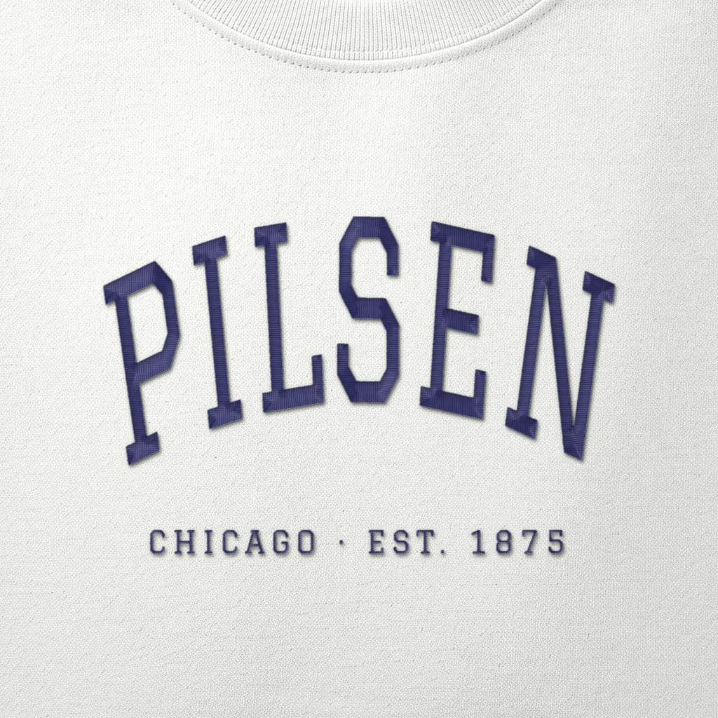 Close-up of navy satin-stitch Pilsen embroidery