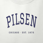 Close-up of navy satin-stitch Pilsen embroidery