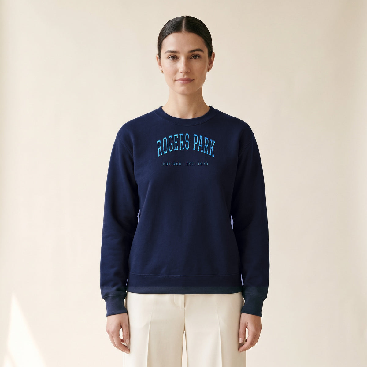 Model wearing the Rogers Park Chicago Embroidered Crewneck — Sky Blue Thread in Navy
