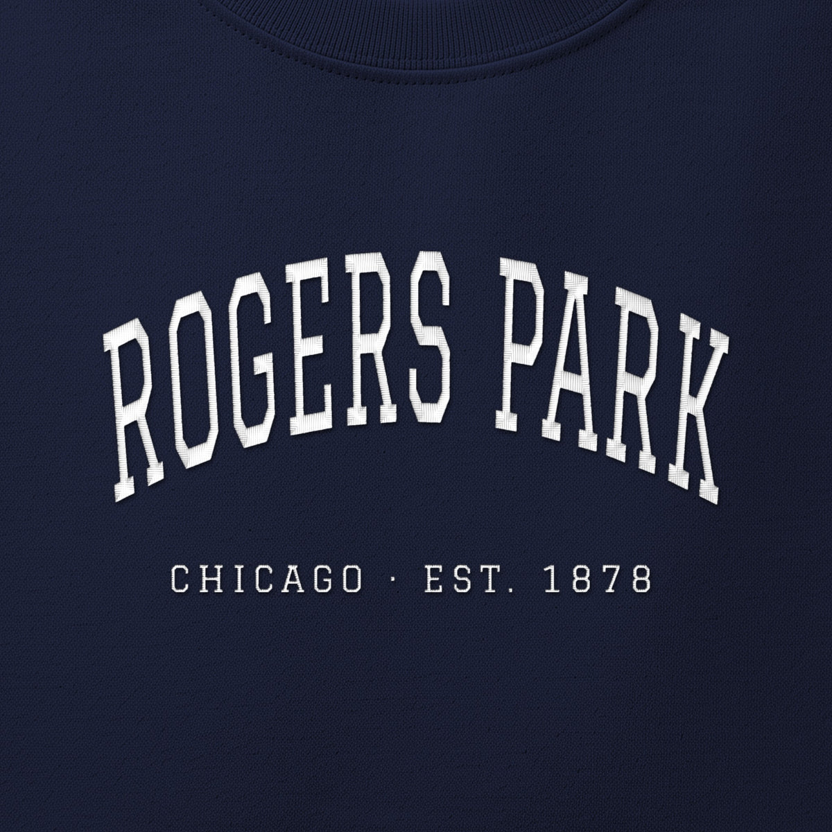 Close-up of white satin-stitch Rogers Park embroidery