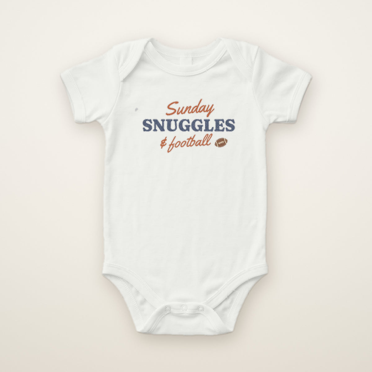 Sunday Snuggles & Football Bodysuit in White, flat lay on ivory