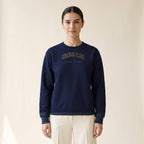 Model wearing the Ukrainian Village Chicago Embroidered Crewneck — Gold Thread in Navy