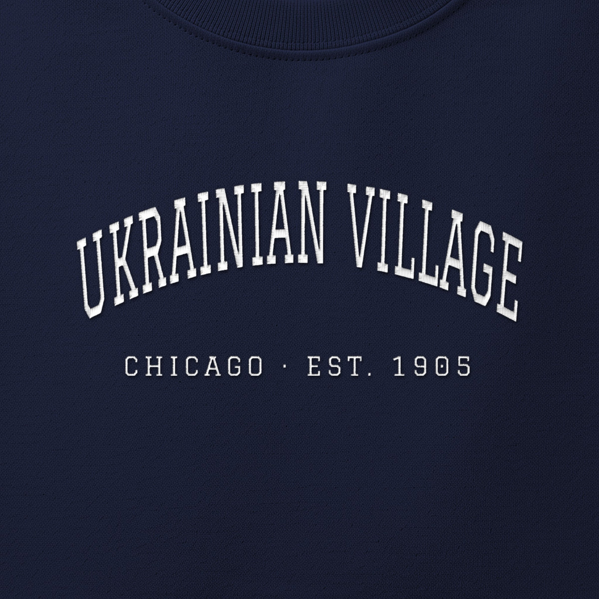 Close-up of white satin-stitch Ukrainian Village embroidery