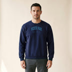 Model wearing the Wicker Park Chicago Embroidered Crewneck — Sky Blue Thread in Navy